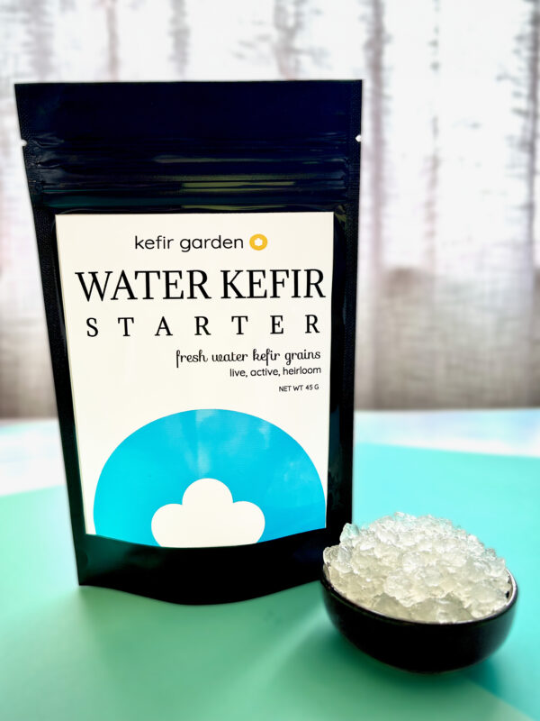 photo of our water kefir grain packaging next to a small bowl of water kefir grains